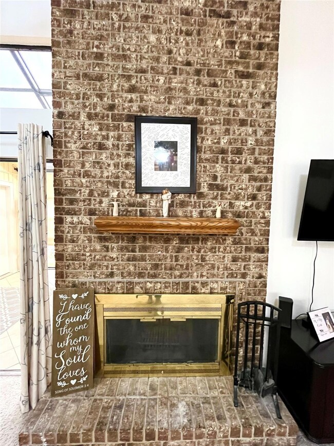 Wall to ceiling brick fireplace.  Wood burning wit