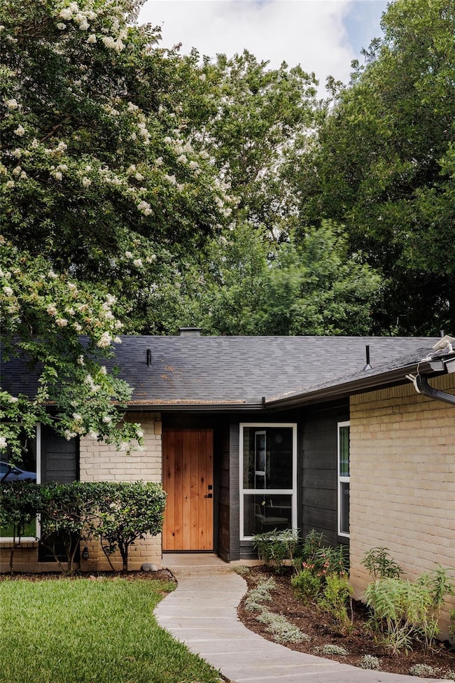 View of front of property featuring brick siding 