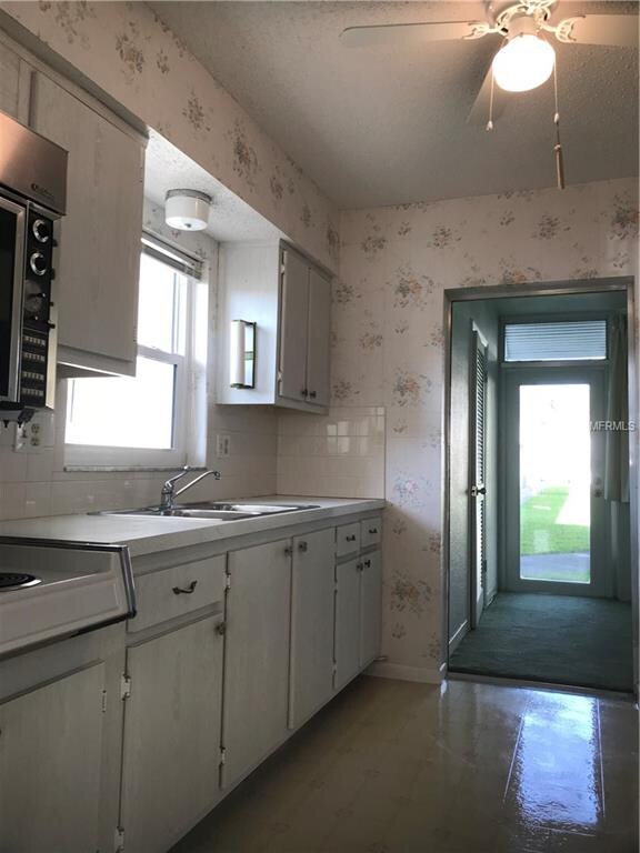 Large eat in kitchen with a window and lot of natu