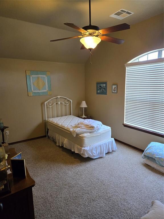 Carpeted bedroom featuring lofted ceiling and ceil