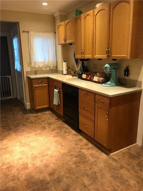 Wide Kitchen with corian counters and dishwasher
