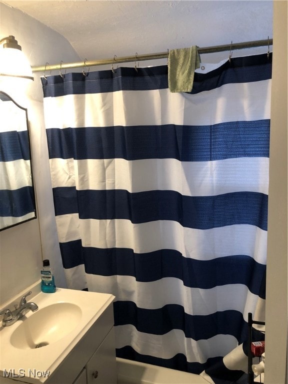 Bathroom with vanity and vaulted ceiling