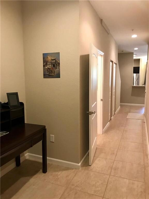 Foyer and hallway that leads to social area. Open