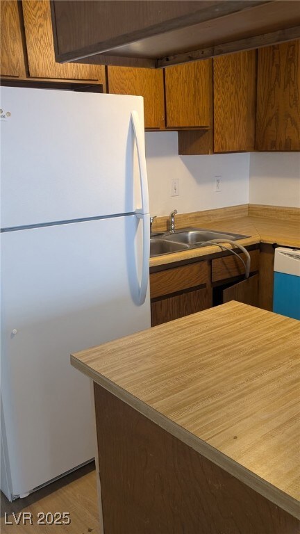 Kitchen with white appliances, light countertops,