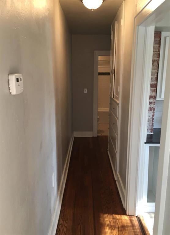 Unit B Corridor with dark wood-type flooring