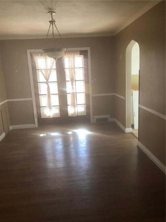 Dining room has arched door leading into the kitch