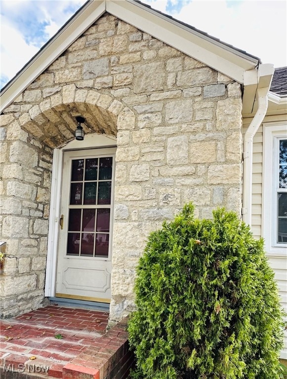 Property entrance with stone siding