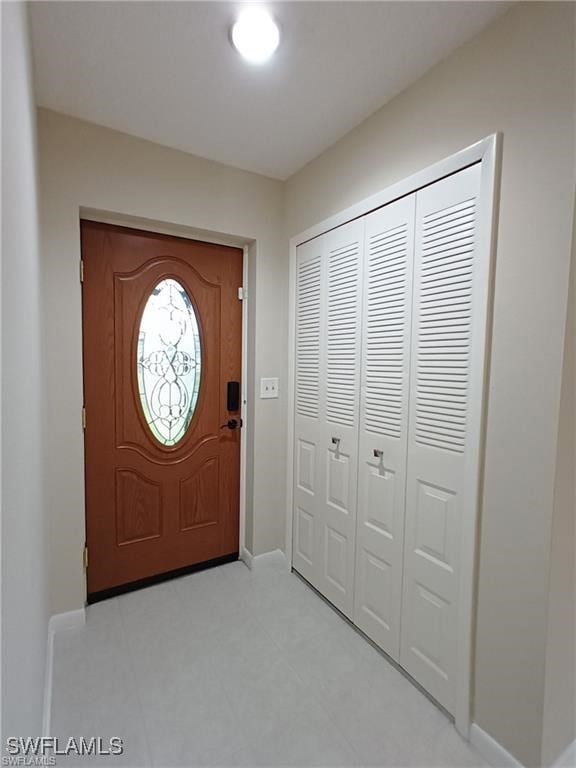 Foyer entrance with baseboards