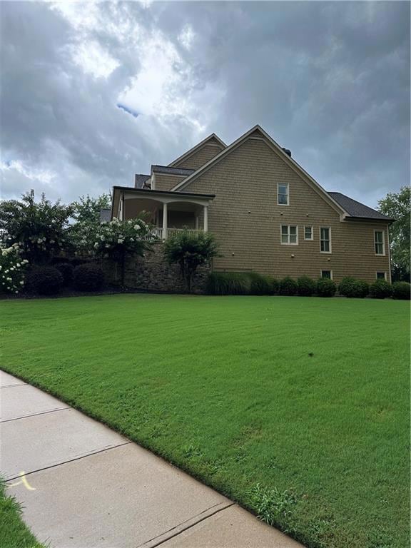 View of home's exterior with a lawn. Sidewalk.