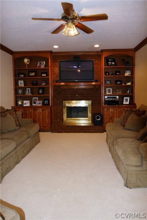 Living Room Features Cozy Fireplace & Built-In She