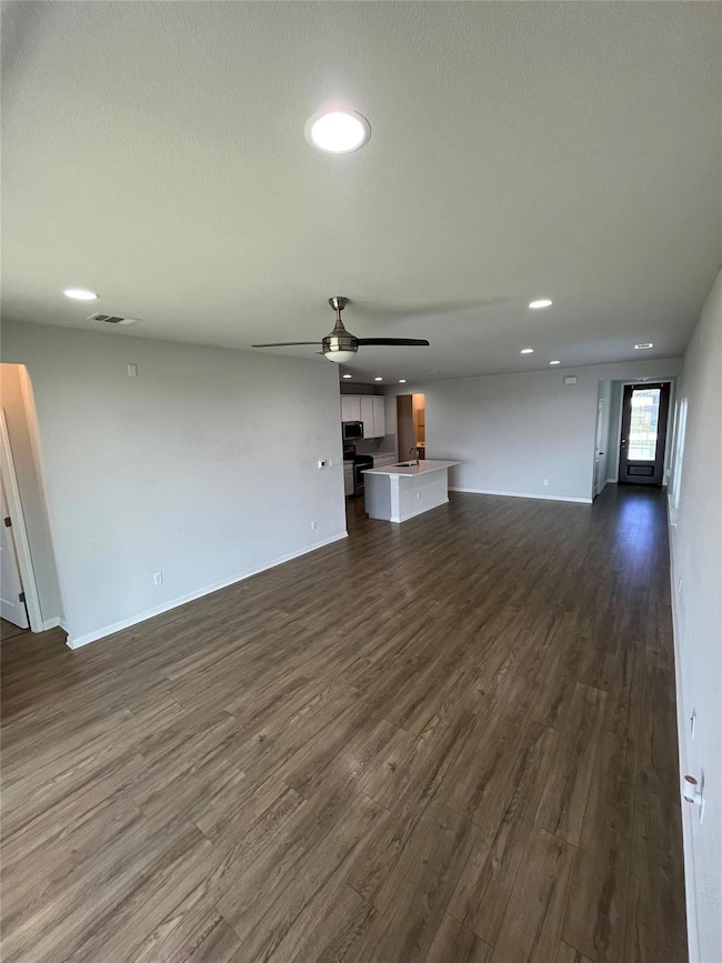Unfurnished living room featuring dark wood finis