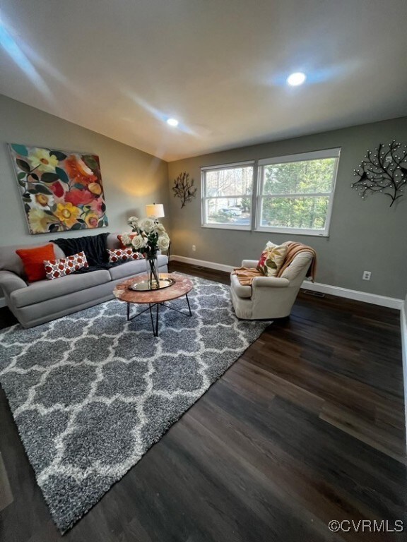 Living room with dark hardwood / wood-style floors