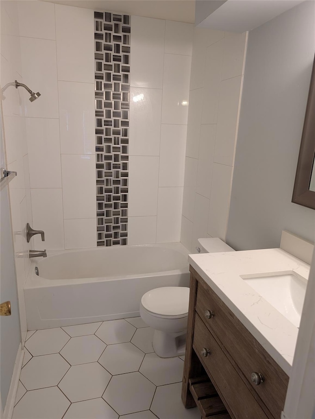 Full bathroom featuring vanity, toilet, and tub /