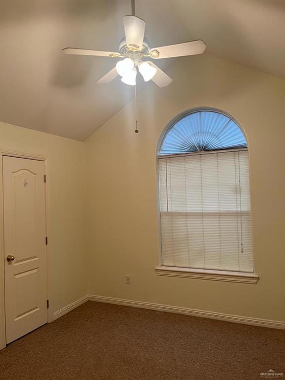 Carpeted empty room with lofted ceiling and ceiling fan