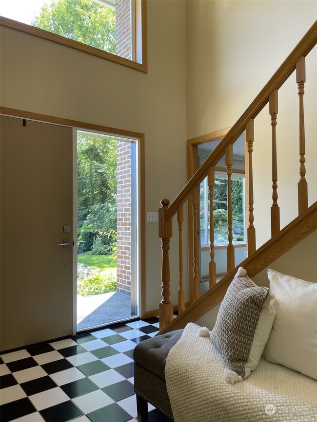 Spacious entry with plenty of closet space and a seating area.