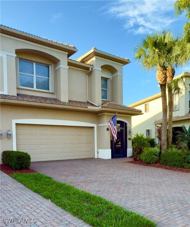 View of front of home with stucco siding, a garage