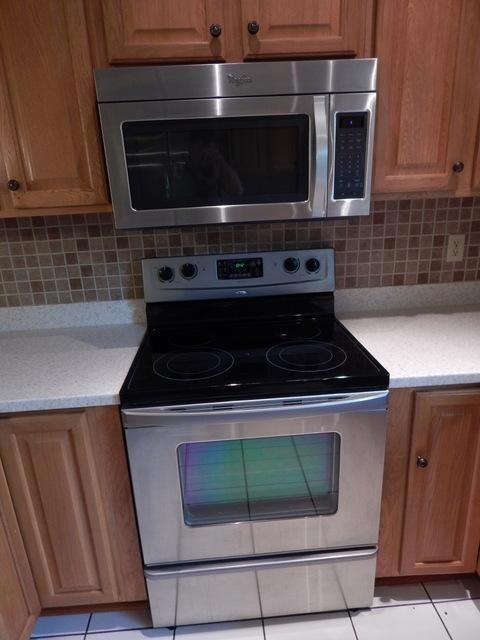 Tiled backsplash, microwave & range