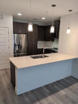 Kitchen featuring stainless steel refrigerator wi