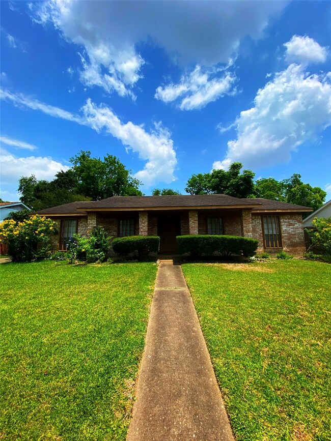 Lovely concrete walkway leads you right up to the home.