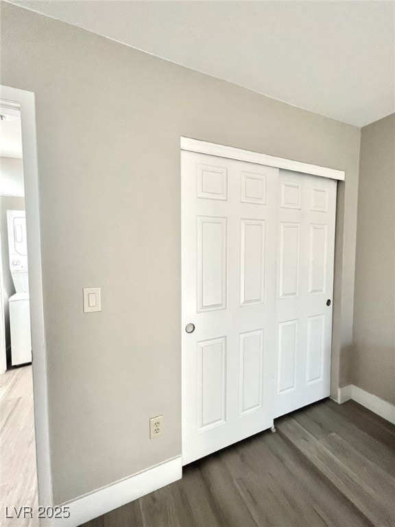 Unfurnished bedroom with stacked washer / drying m