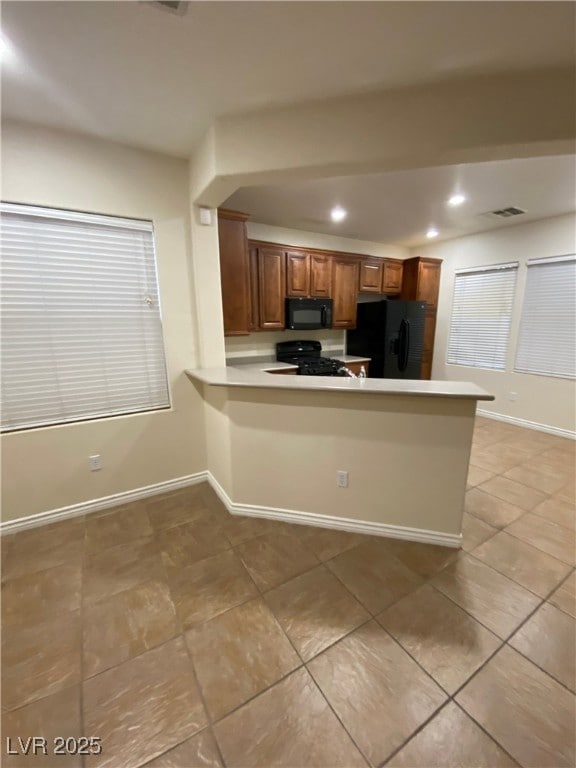 Kitchen featuring a peninsula, recessed lighting,