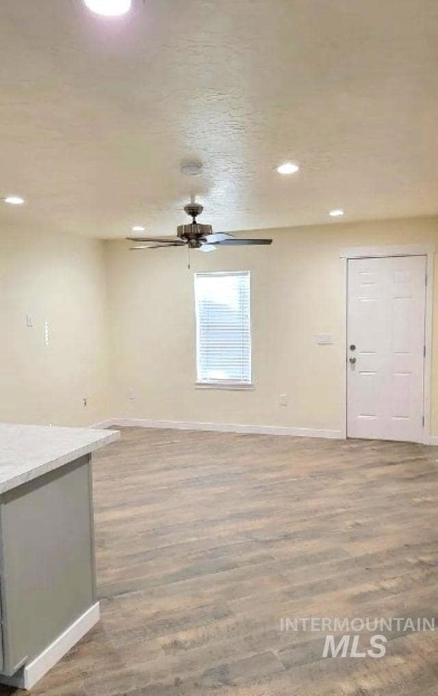 Unfurnished room with light wood-style flooring, recessed lighting, and a textured ceiling