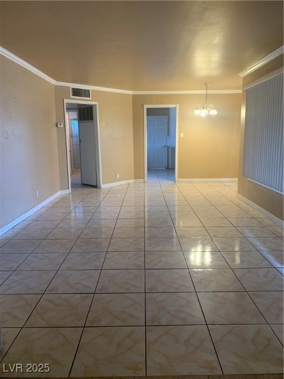 Empty room featuring crown molding, light tile pat