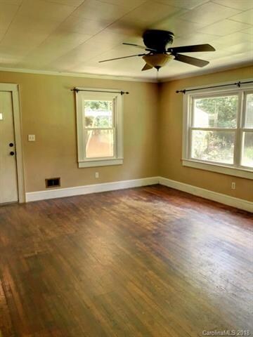 Hardwood floors and ceiling fan in living room.