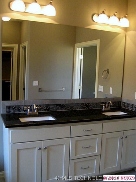 Dual sinks in Master with travertine floors.