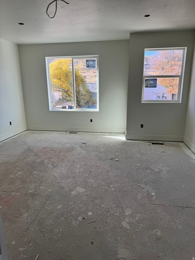 Unfurnished room with plenty of natural light and a textured ceiling