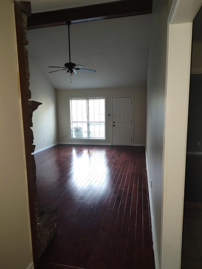 Spare room featuring baseboards, a ceiling fan, an
