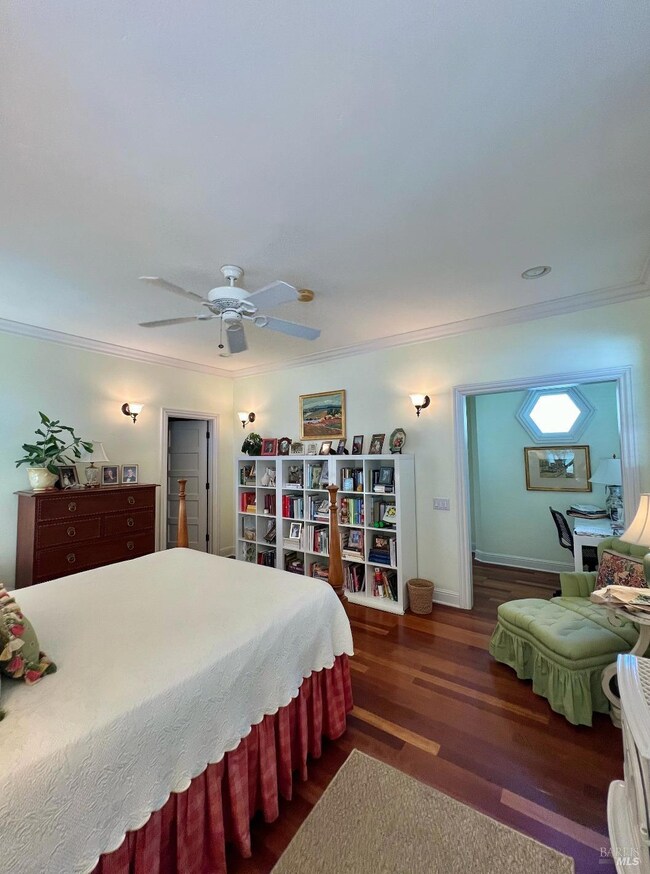 Primary bedroom with walk in closet to the left and full bath with balcony on the main level.