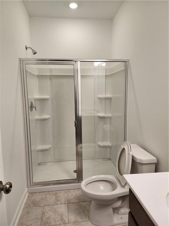 Full bath with marble finish floor, toilet, vanity