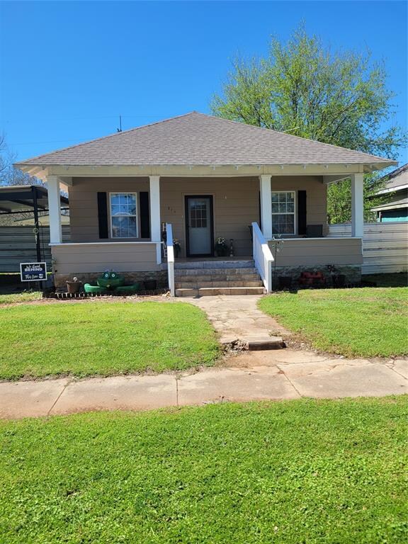 View of front of property featuring covered porch 