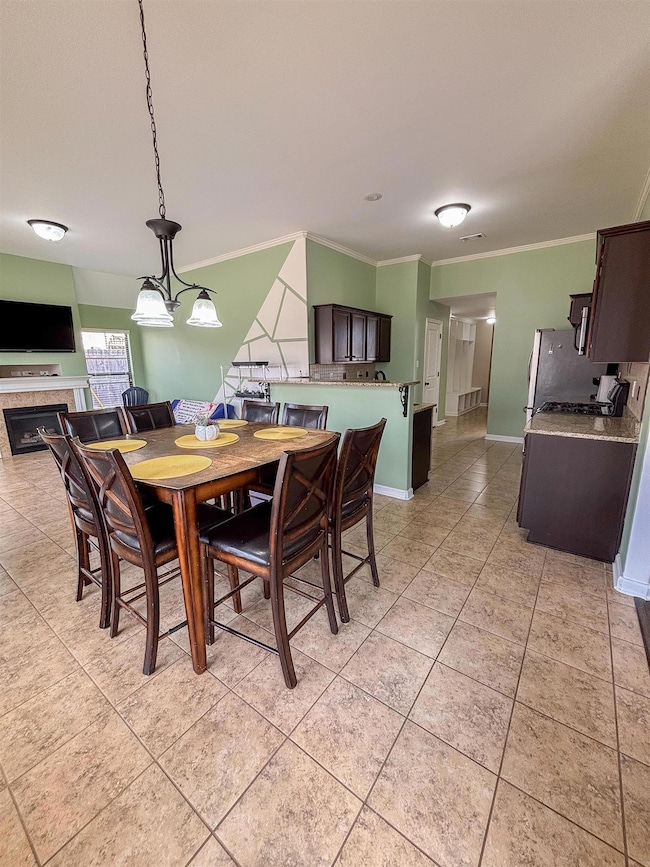 Dining space featuring light tile patterned floors
