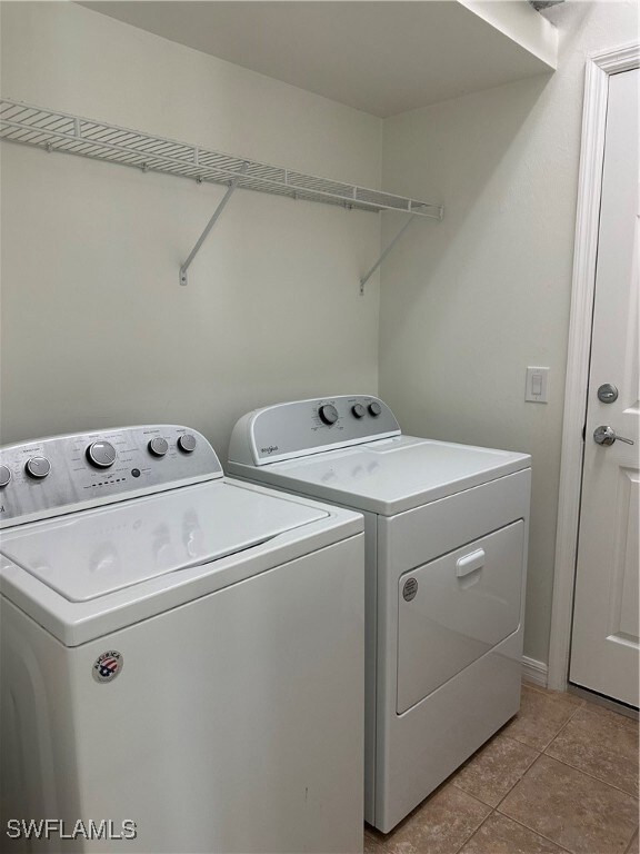Laundry area off garage featuring  washer and dryer