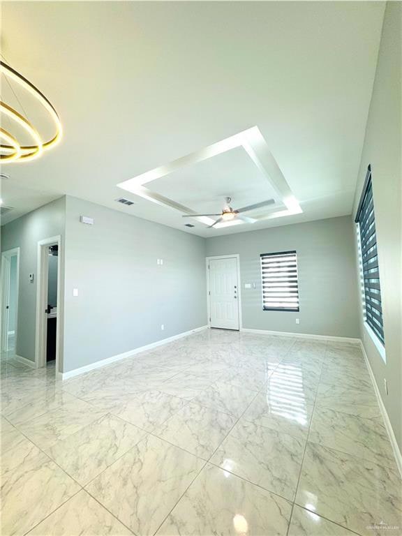 Empty room with ceiling fan and light marble finish flooring