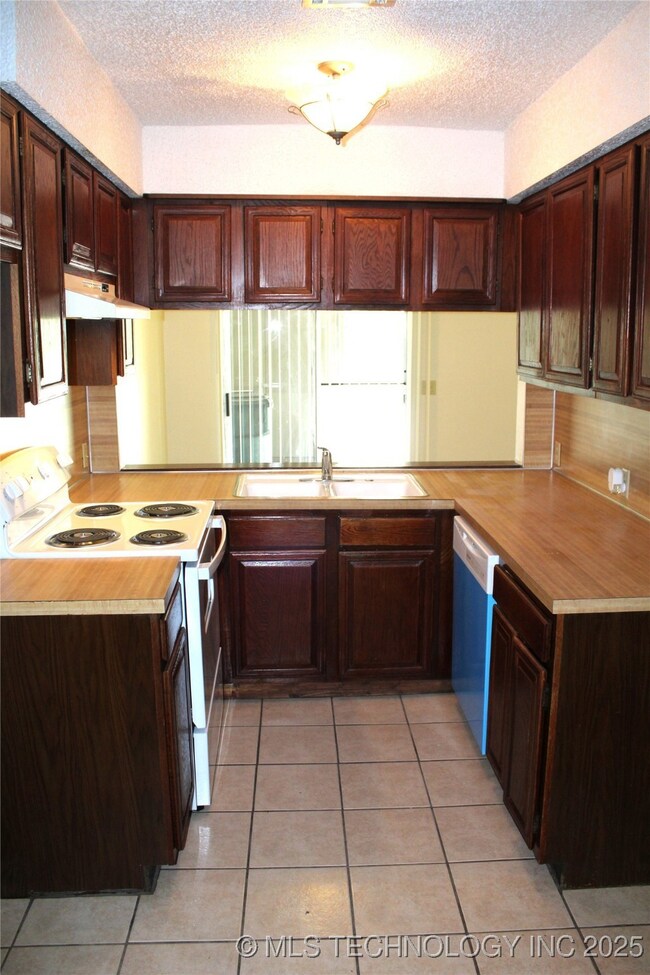 Kitchen features new stove and new dishwasher too!
