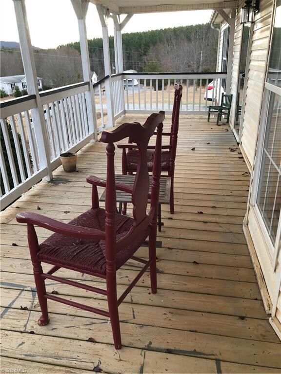 Featuring a beautiful rocking chair front porch with a beautiful mountain view.