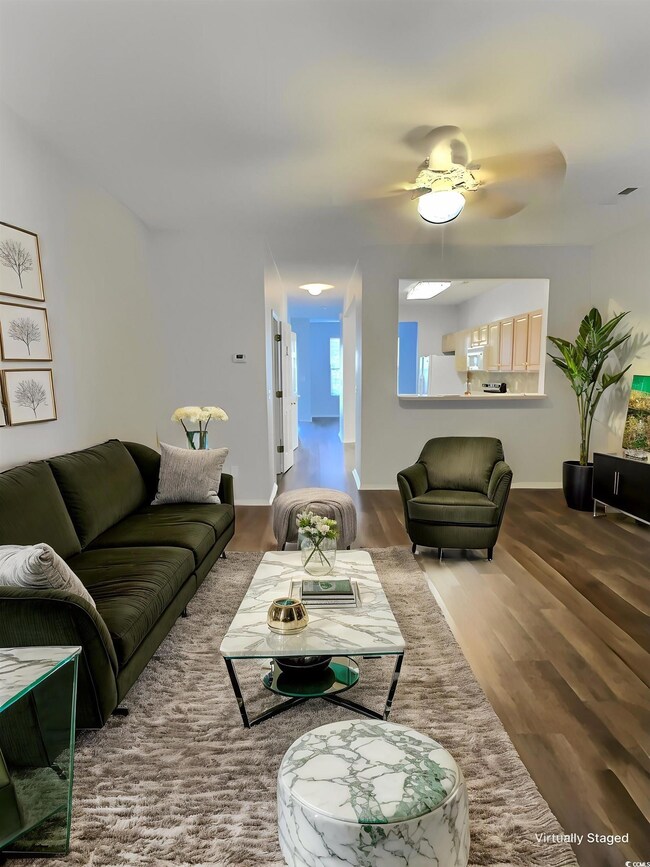 Living area featuring ceiling fan and wood finishe