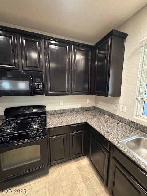 Kitchen featuring range, light tile patterned floo