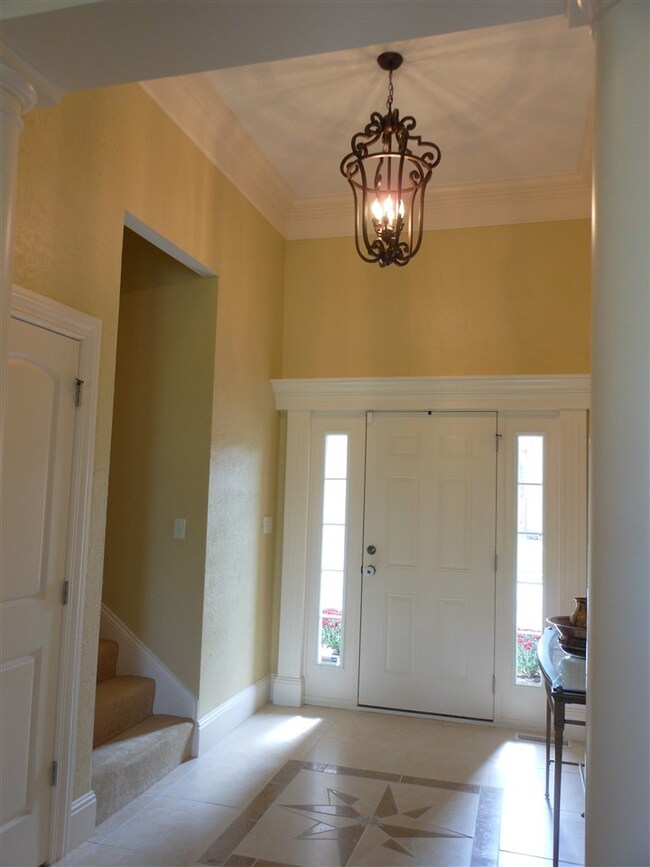 Light filled entry way opens into large family roo