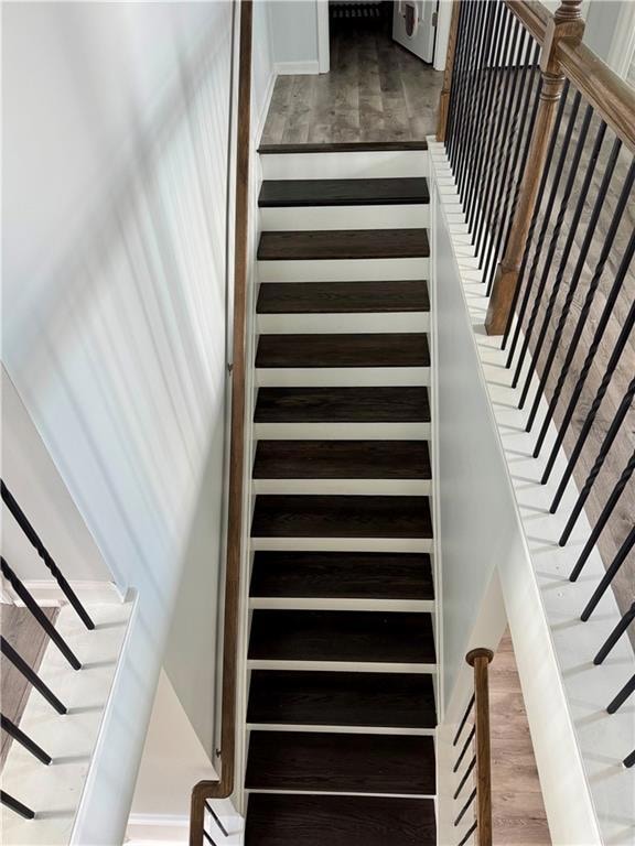 Stairway featuring wood finished floors