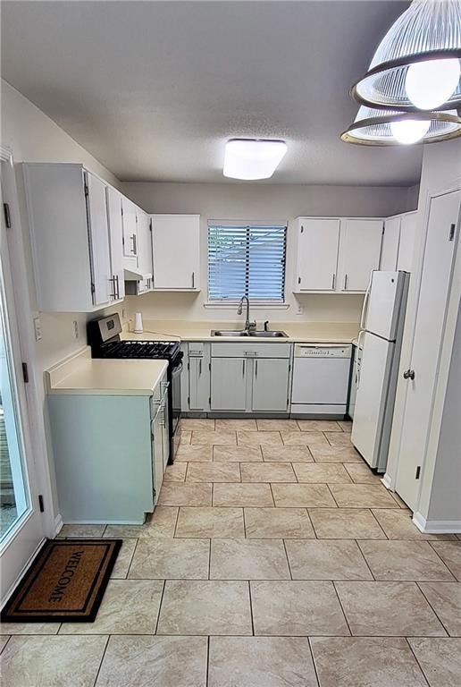 Kitchen featuring white cabinets, white appliances