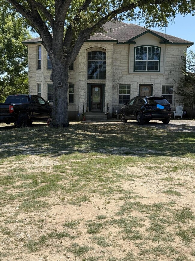 French provincial home featuring a front lawn, a 