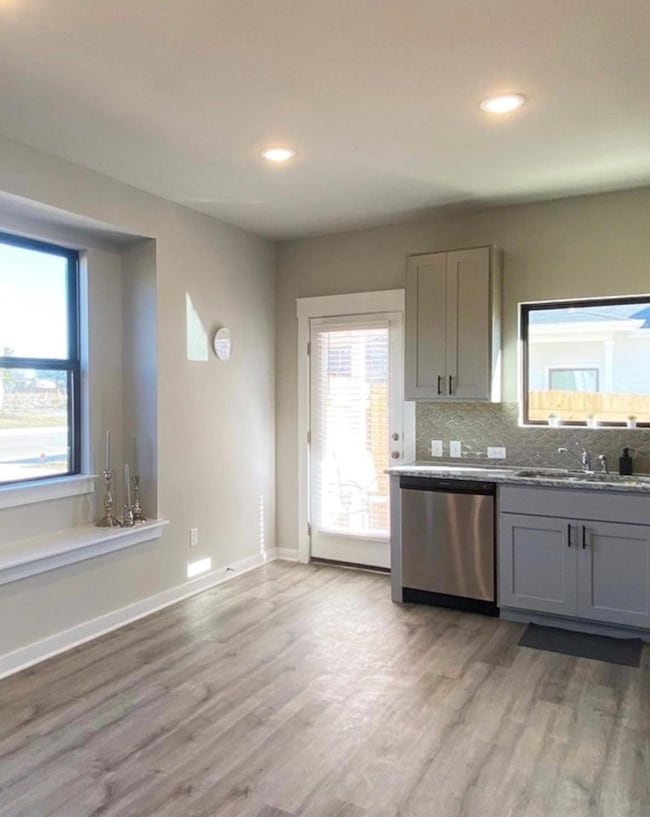 Kitchen with stainless steel dishwasher, gray cab