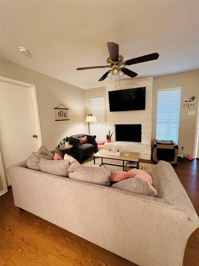 Living area with dark wood-style flooring, a ceil