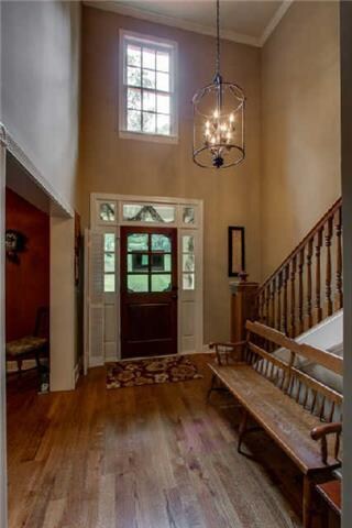 With hardwood floors, this two-story Entryway welc
