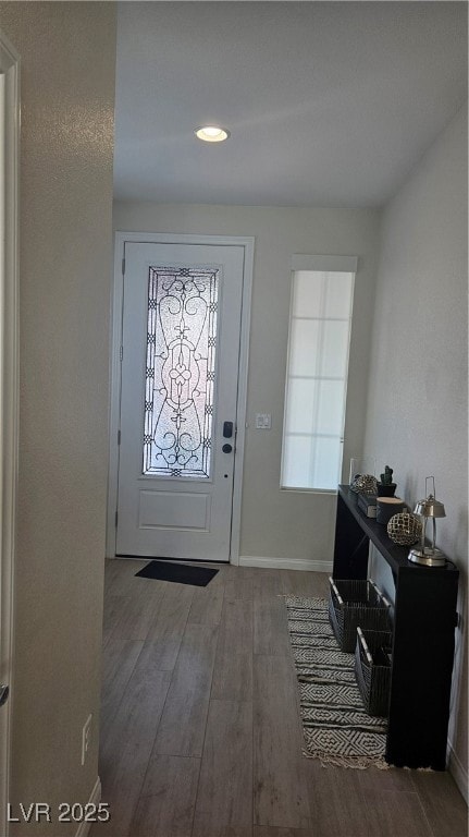 Entryway featuring wood finished floors and recess