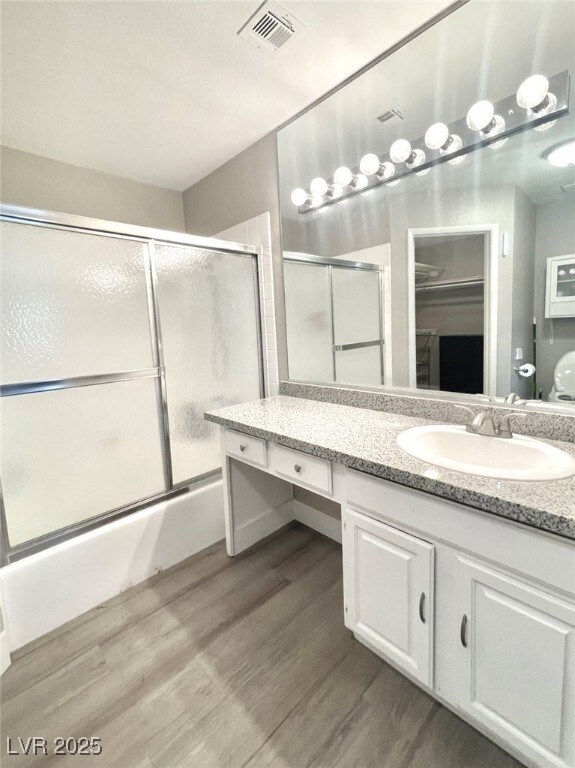 Bathroom with vanity, combined bath / shower with